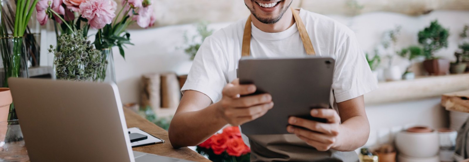 a person using their tablet and laptop